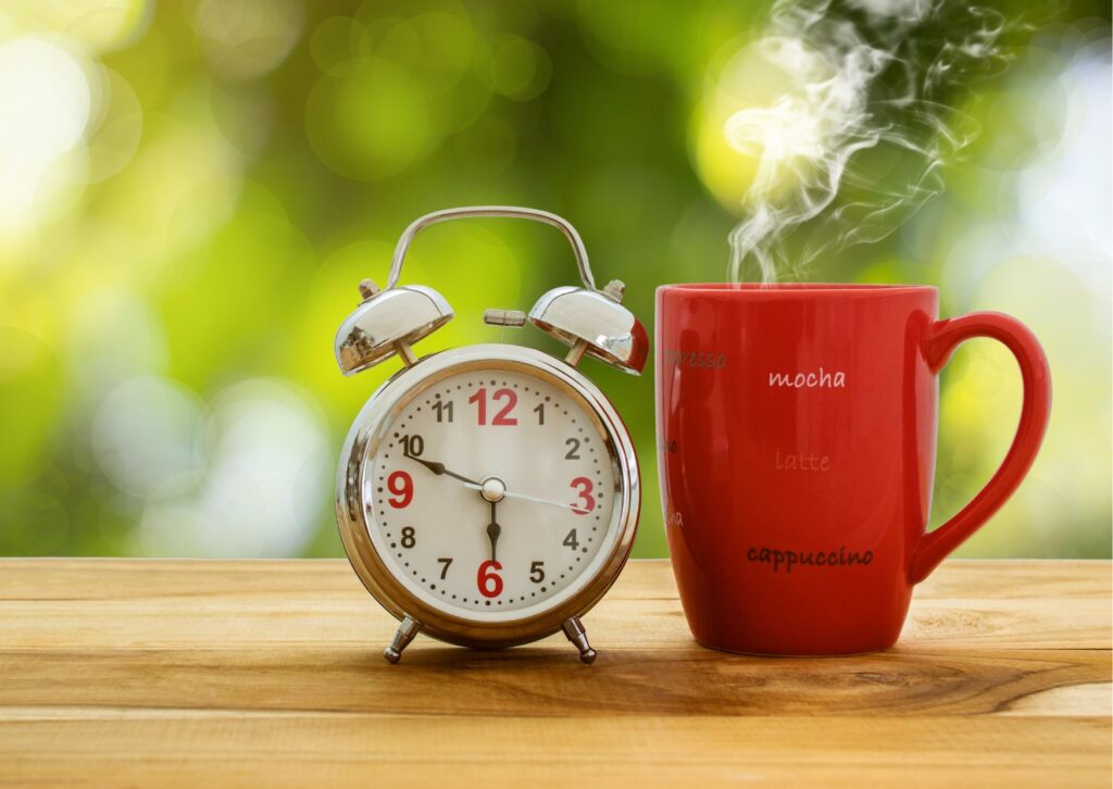 alarm clock and coffee in the morning on a table