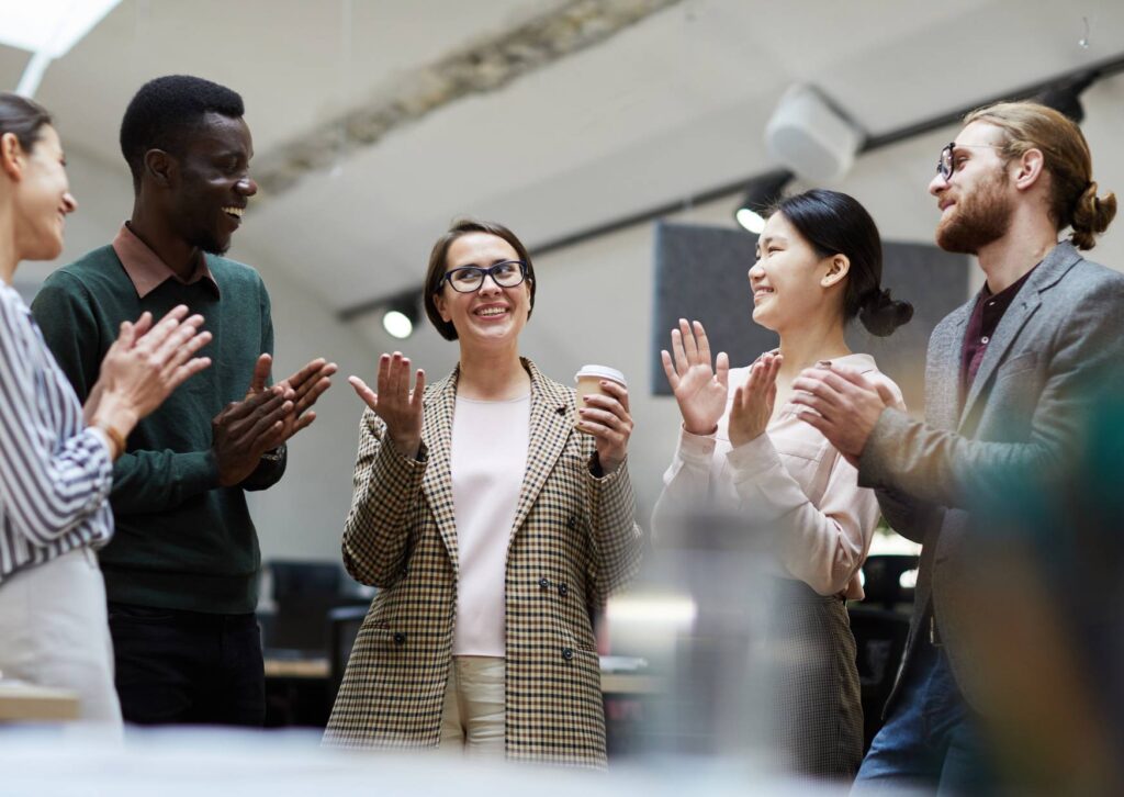 colleagues-laughing-together-and-clapping