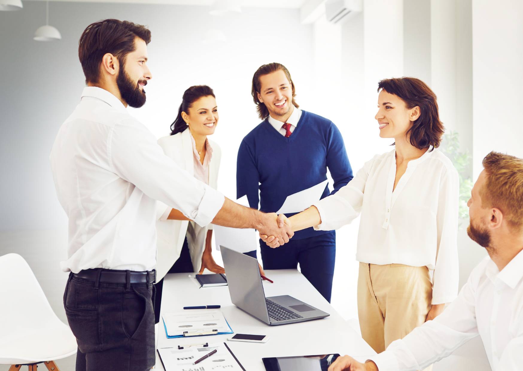 colleagues-showing-appreciation-to-each-other-shaking-hands-and-smiling