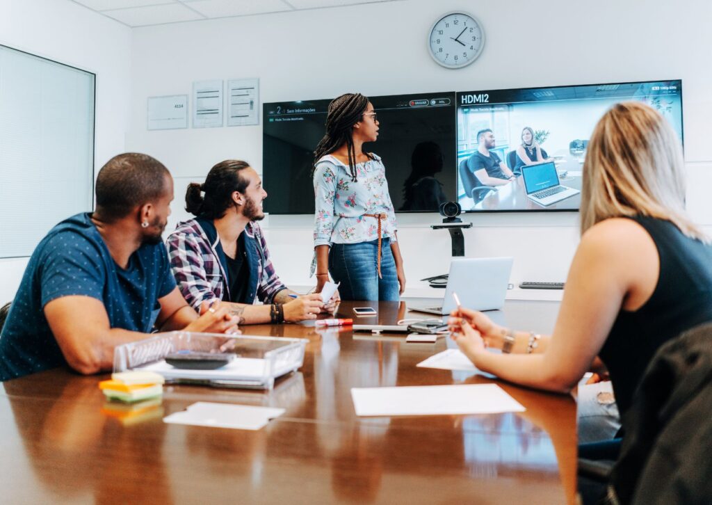 employees-in-a-team-meeting-looking-at-a-screen