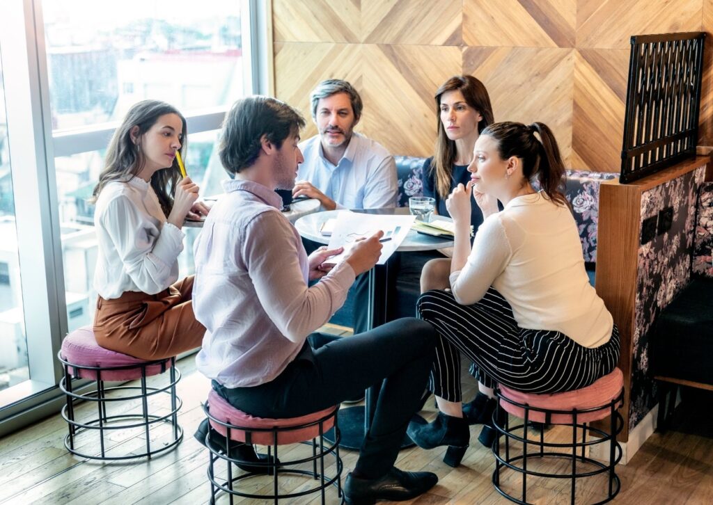 employees in a team meeting talking