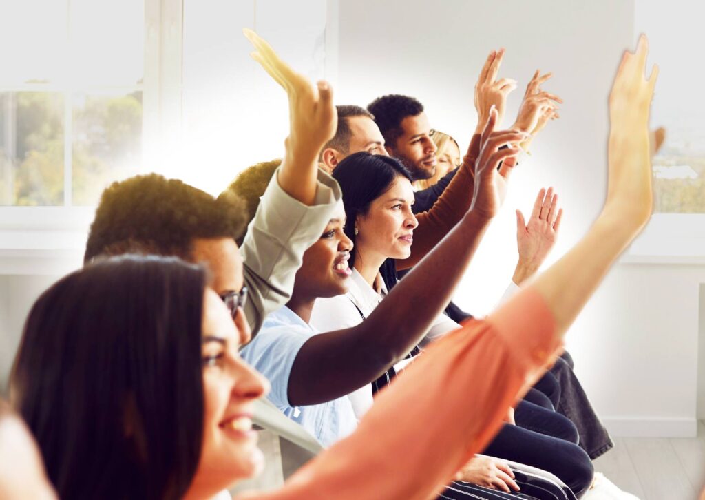 employees-with-hands-up-participating-in-a-wellness-workshop