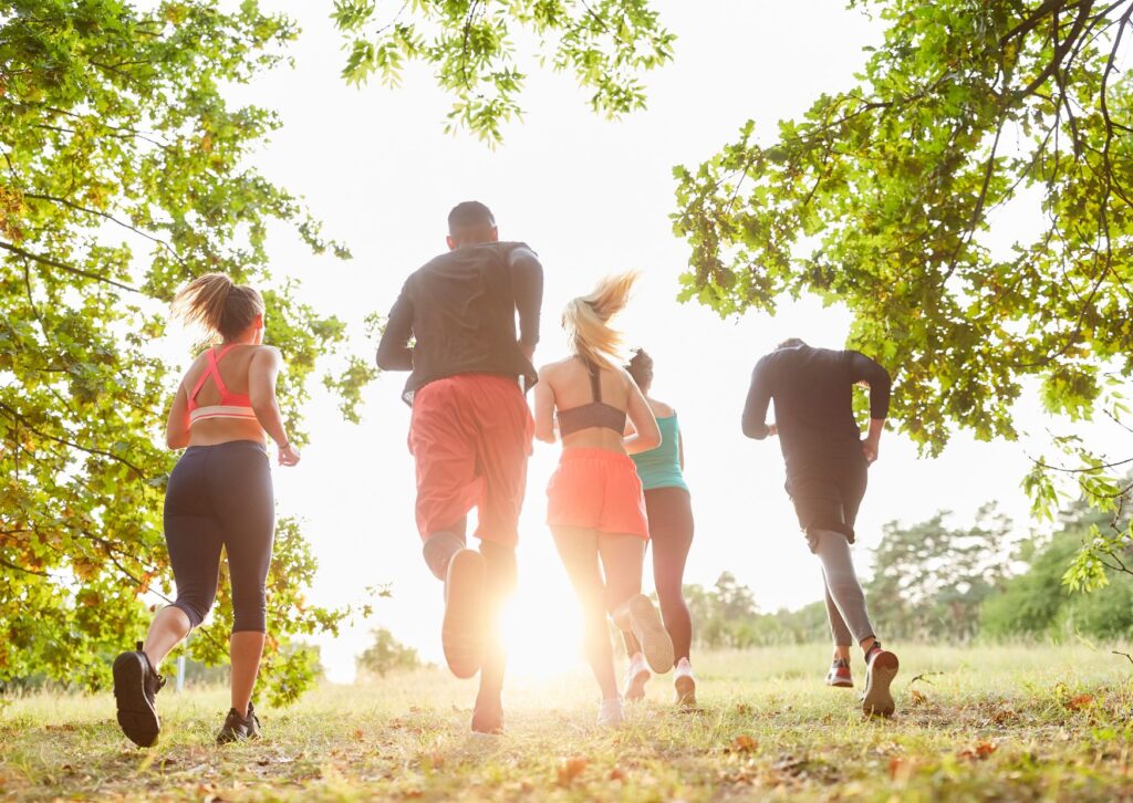 group-of-people-running-towards-sunlight