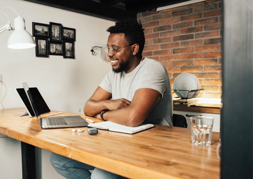 happy-black-man-working-from-home-at-a-desk