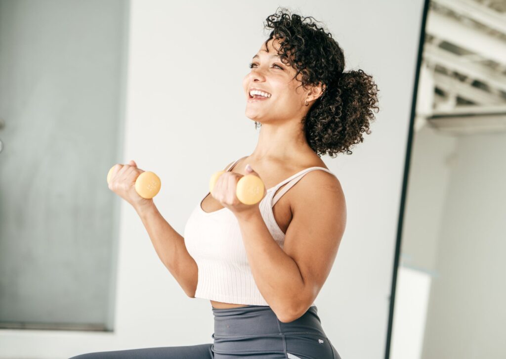 happy lady exercising and lifting weights as her new habit