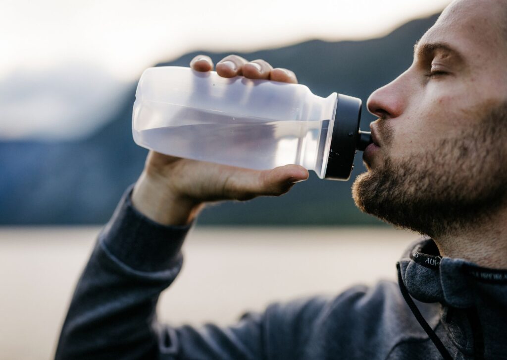 Man drinking water to stay hydrated