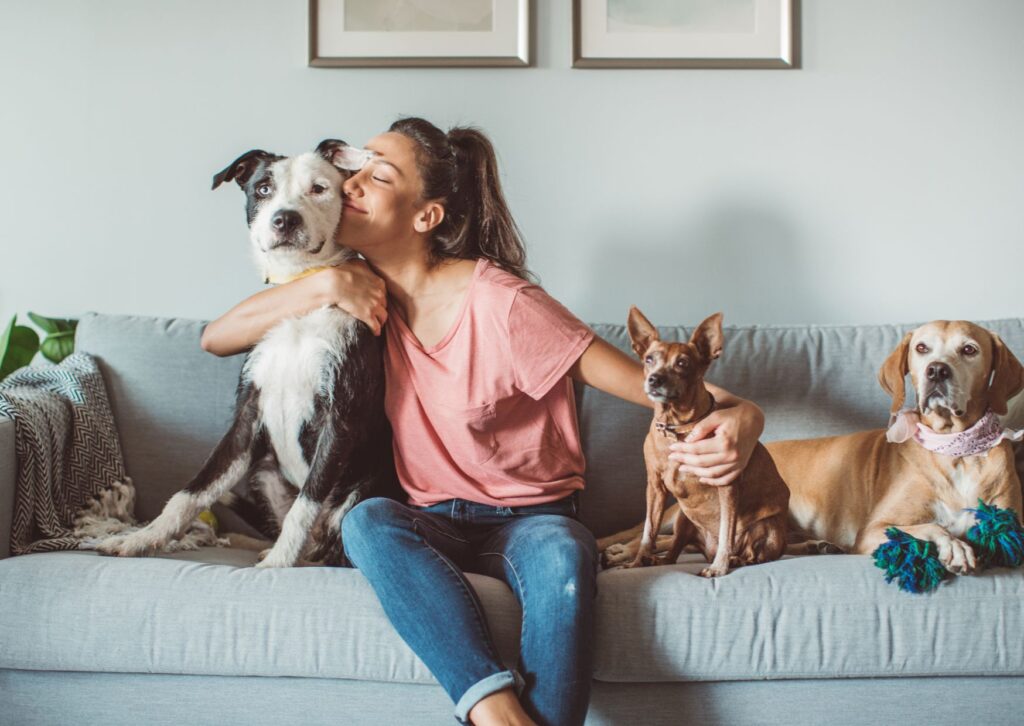 lady-on-the-sofa-hugging-her-pet-dog-