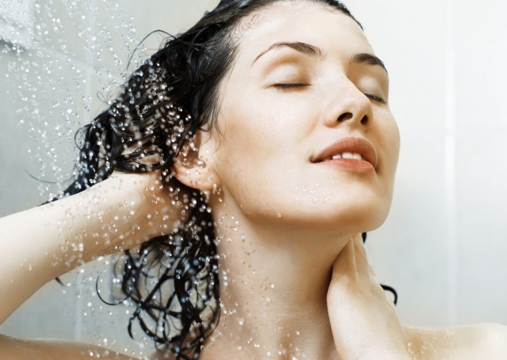 lady washing her hair in the cold shower