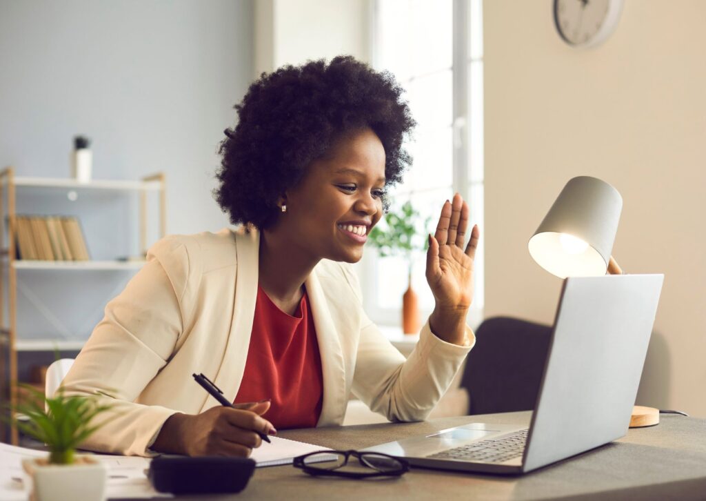 lady-waving-at-her-laptop