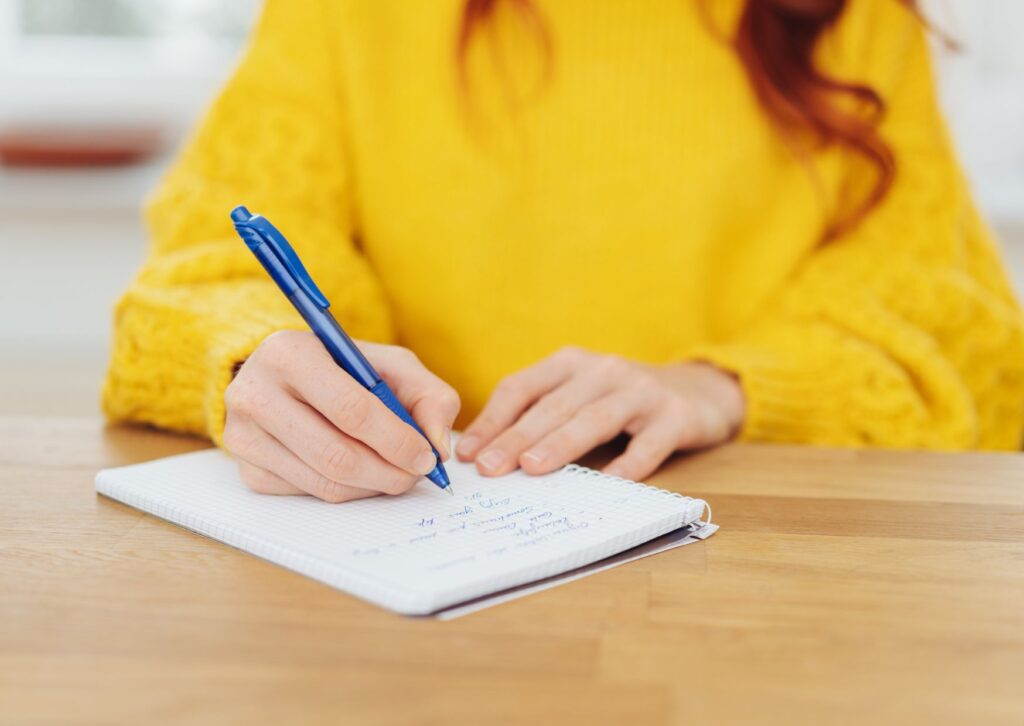 lady-writing-on-a-notepad