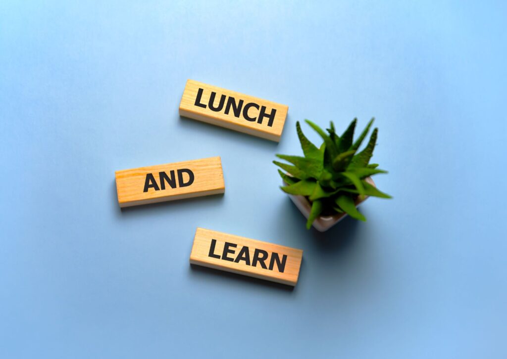 lunch-and-learn-written-on-some-small-jenga-bricks-on-a-blue-background