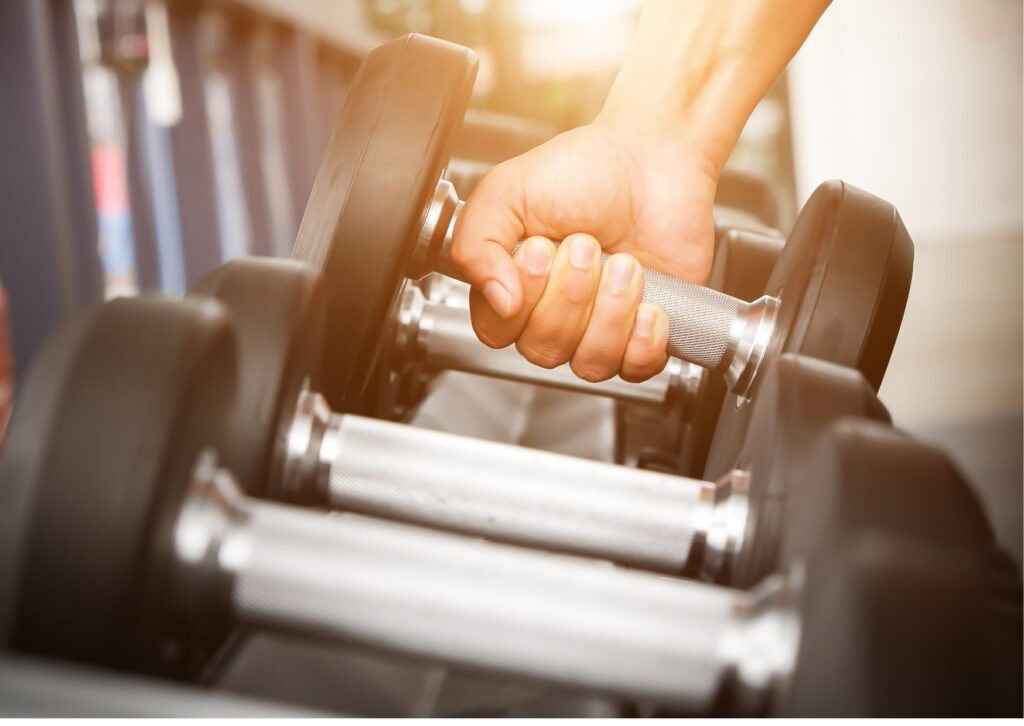 male-hand-picking-up-a-dumbbell