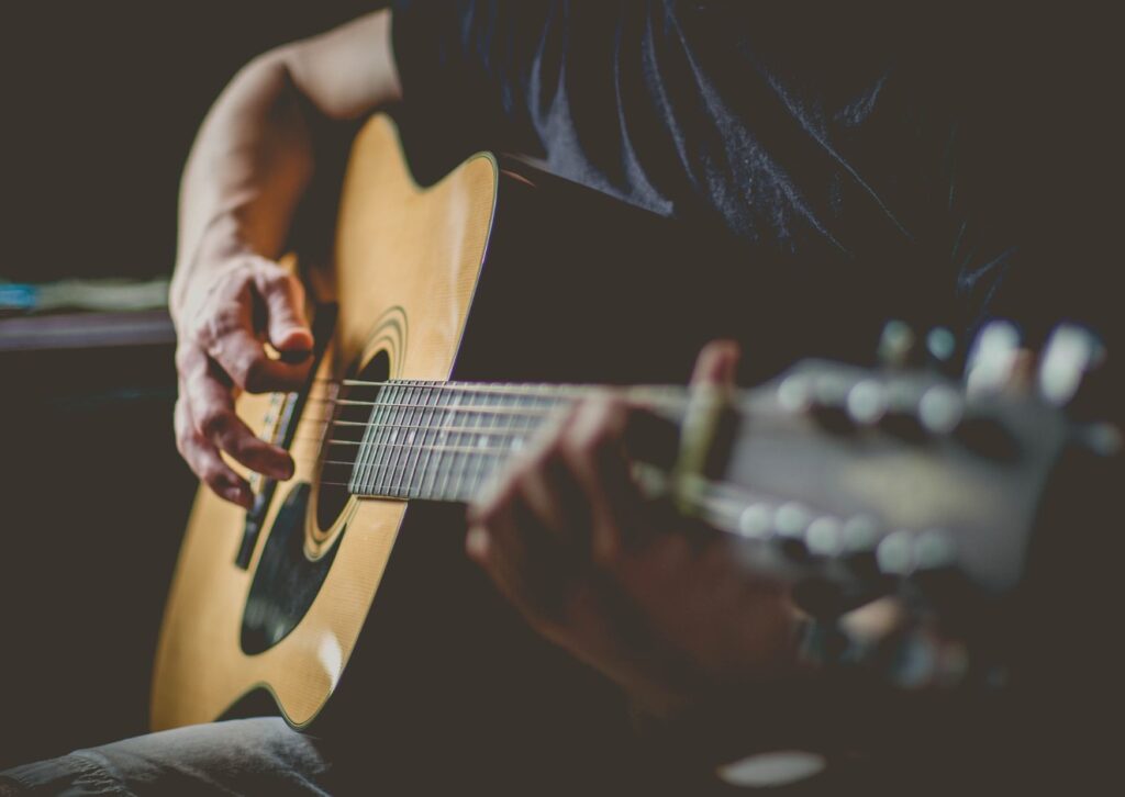 Man learning to play the guitar