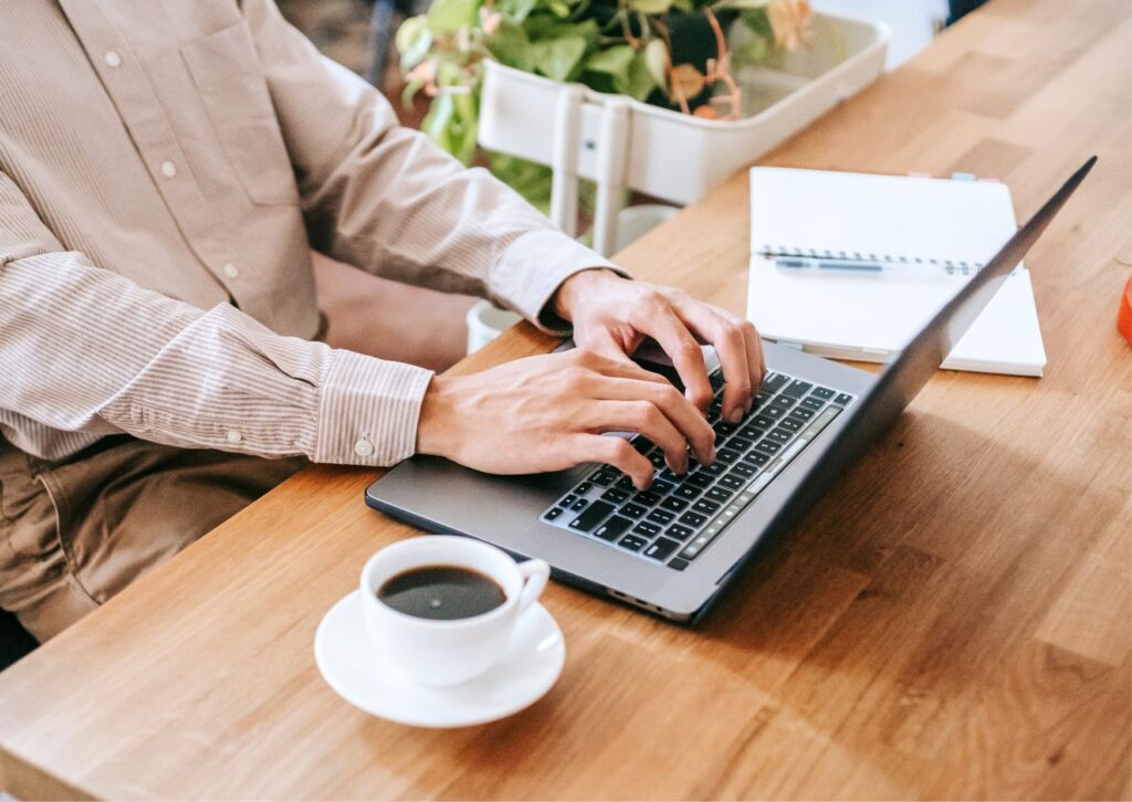 man-on-a-laptop-with-a-coffee