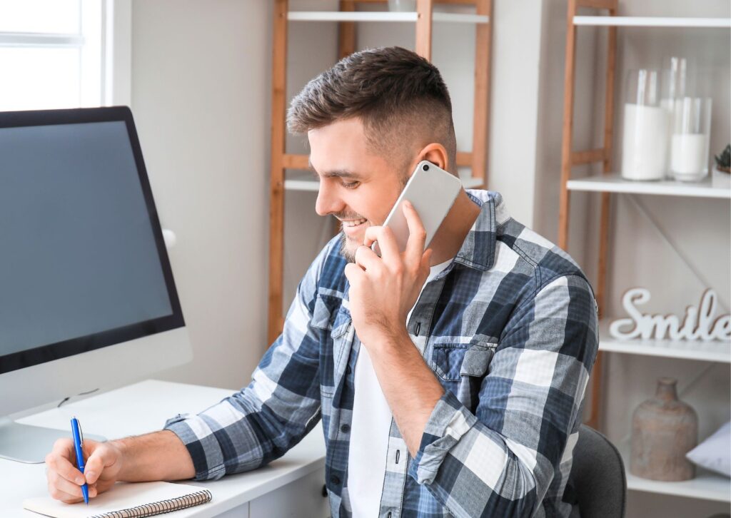 man-on-phone-at-his-work-desk