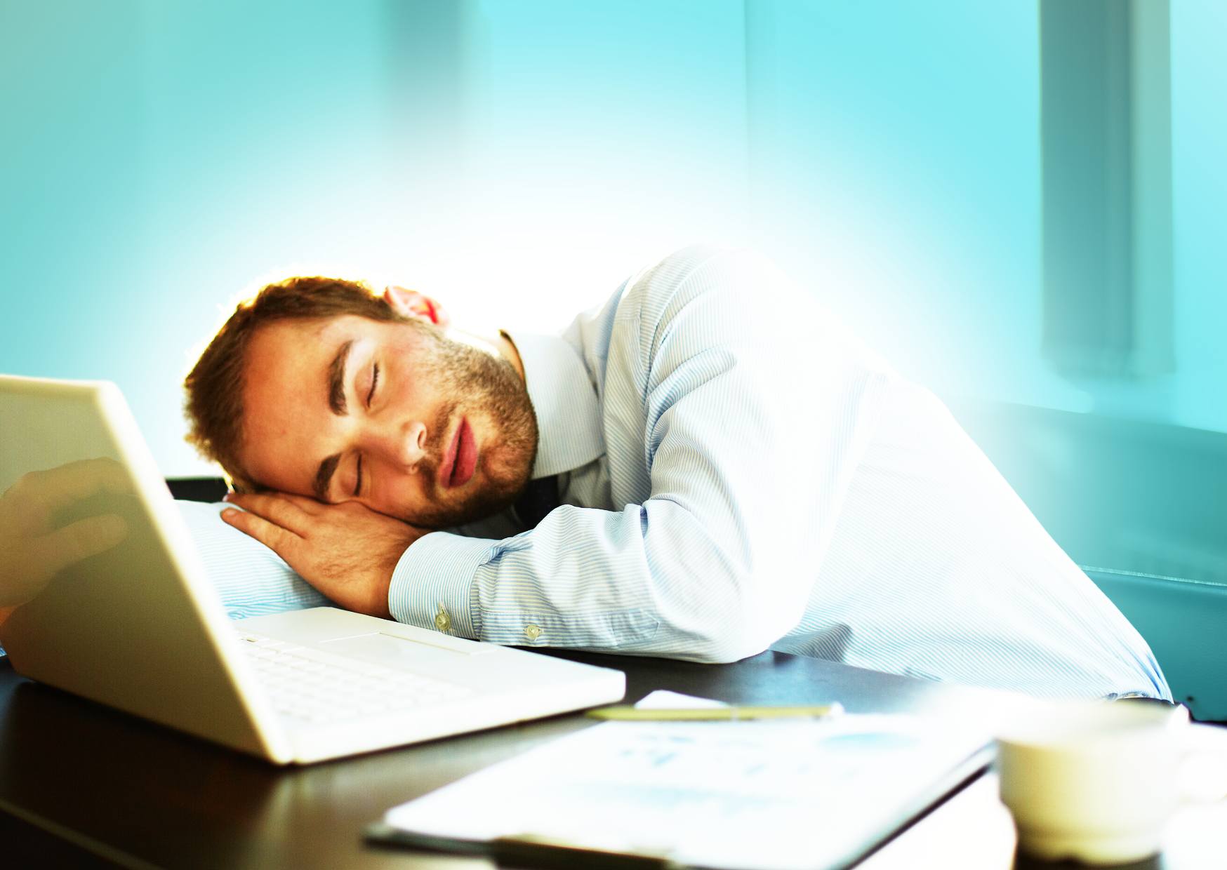 man-resting-and-sleeping-at-his-desk-during-his-working-day