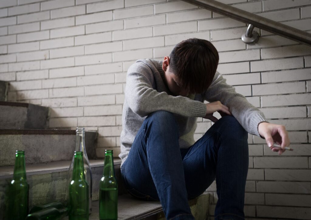 man struggling with heath smoking on the stairs