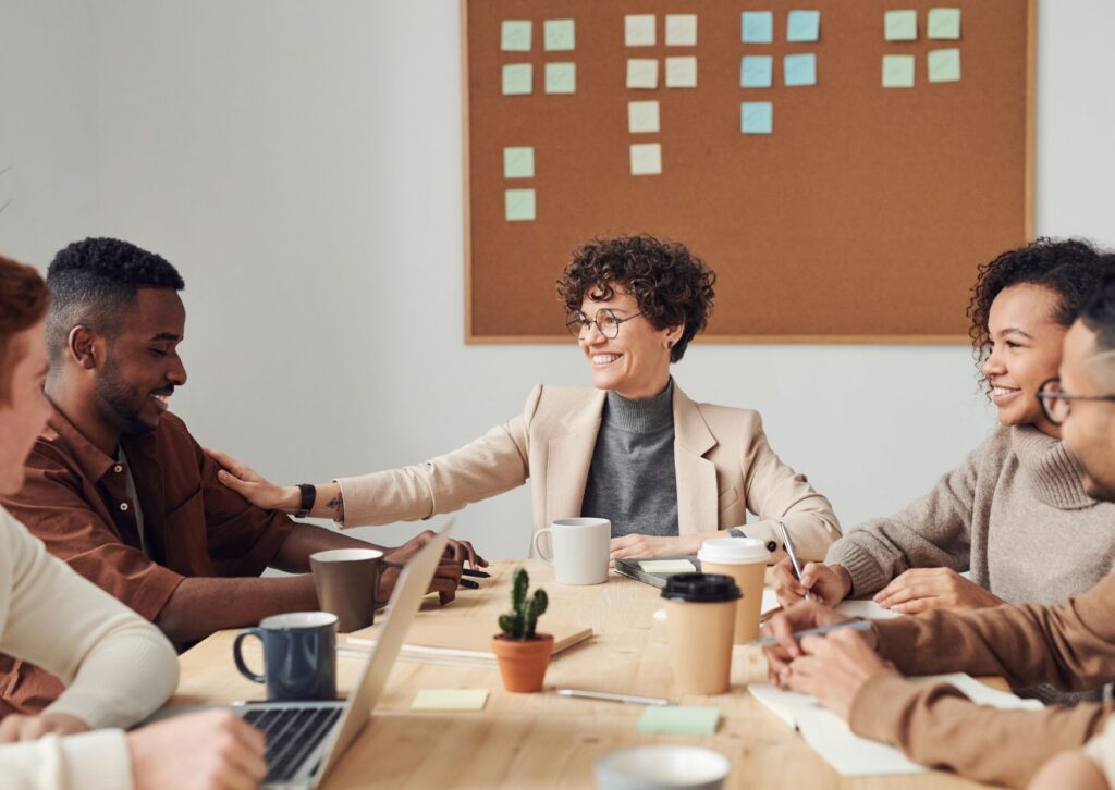 manager supporting her employee in a team meeting