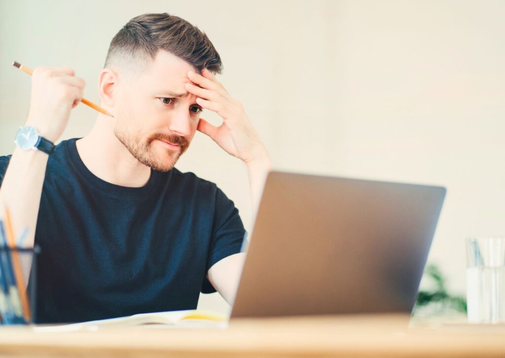 remote worker with hand on his head