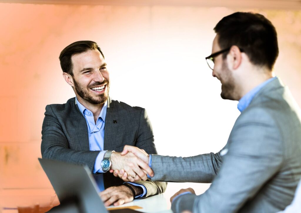 senior-leader-shaking-hands-with-his-executive-coach