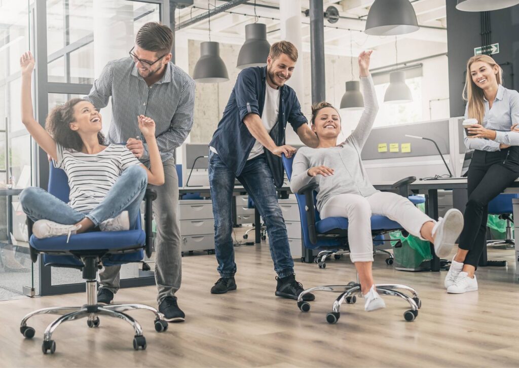 staff-having-fun-in-office-chairs-at-work