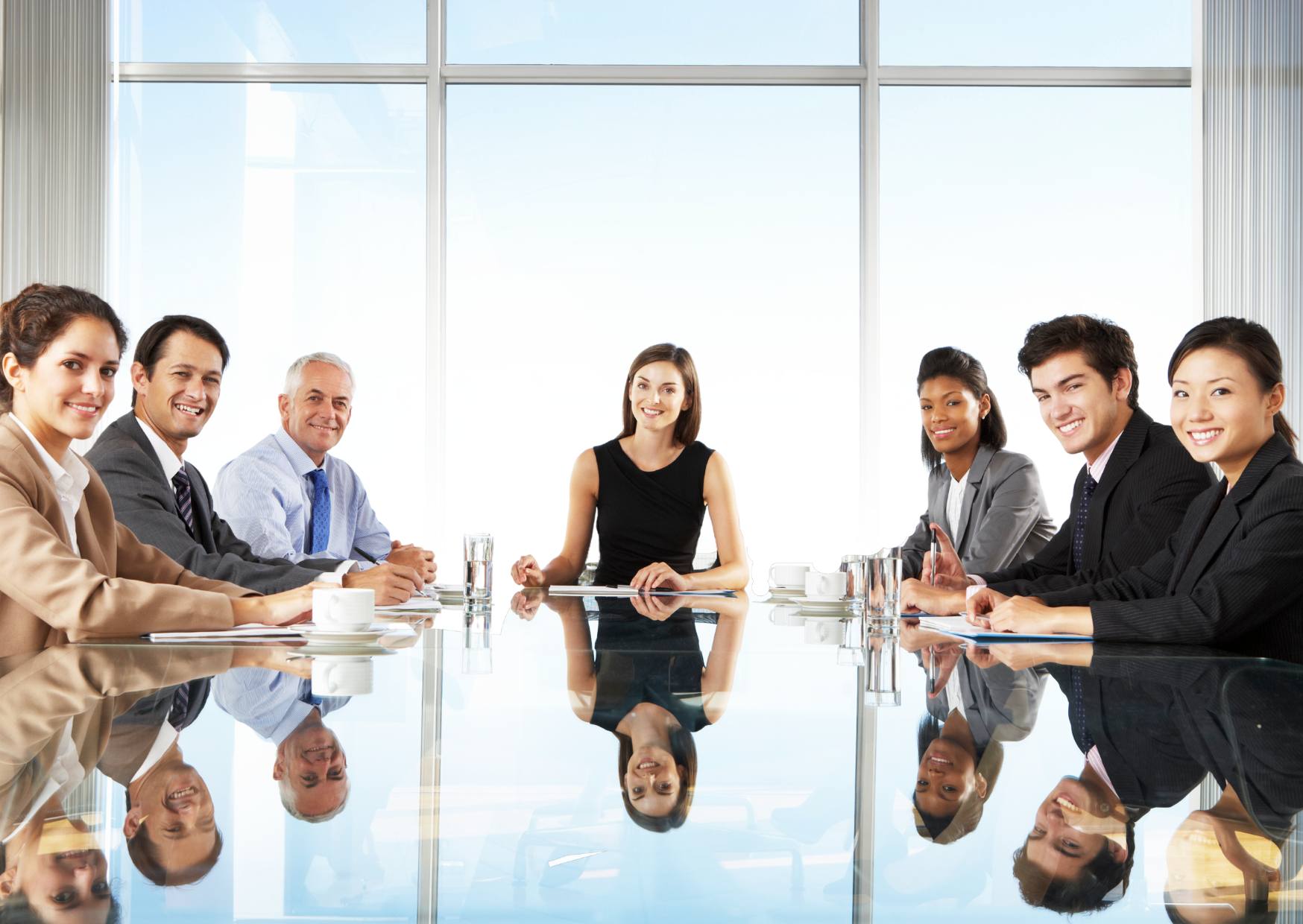 staff-in-a-board-meeting-with-a-woman-at-the-head-of-the-table