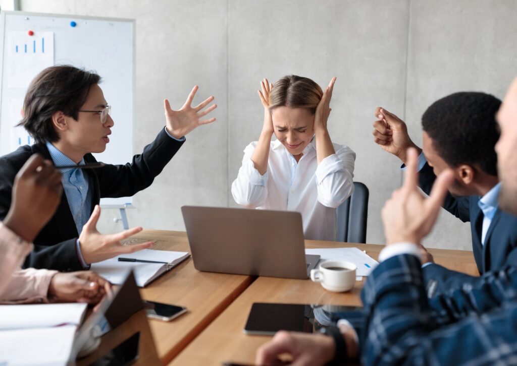 woman being shouted at by colleagues